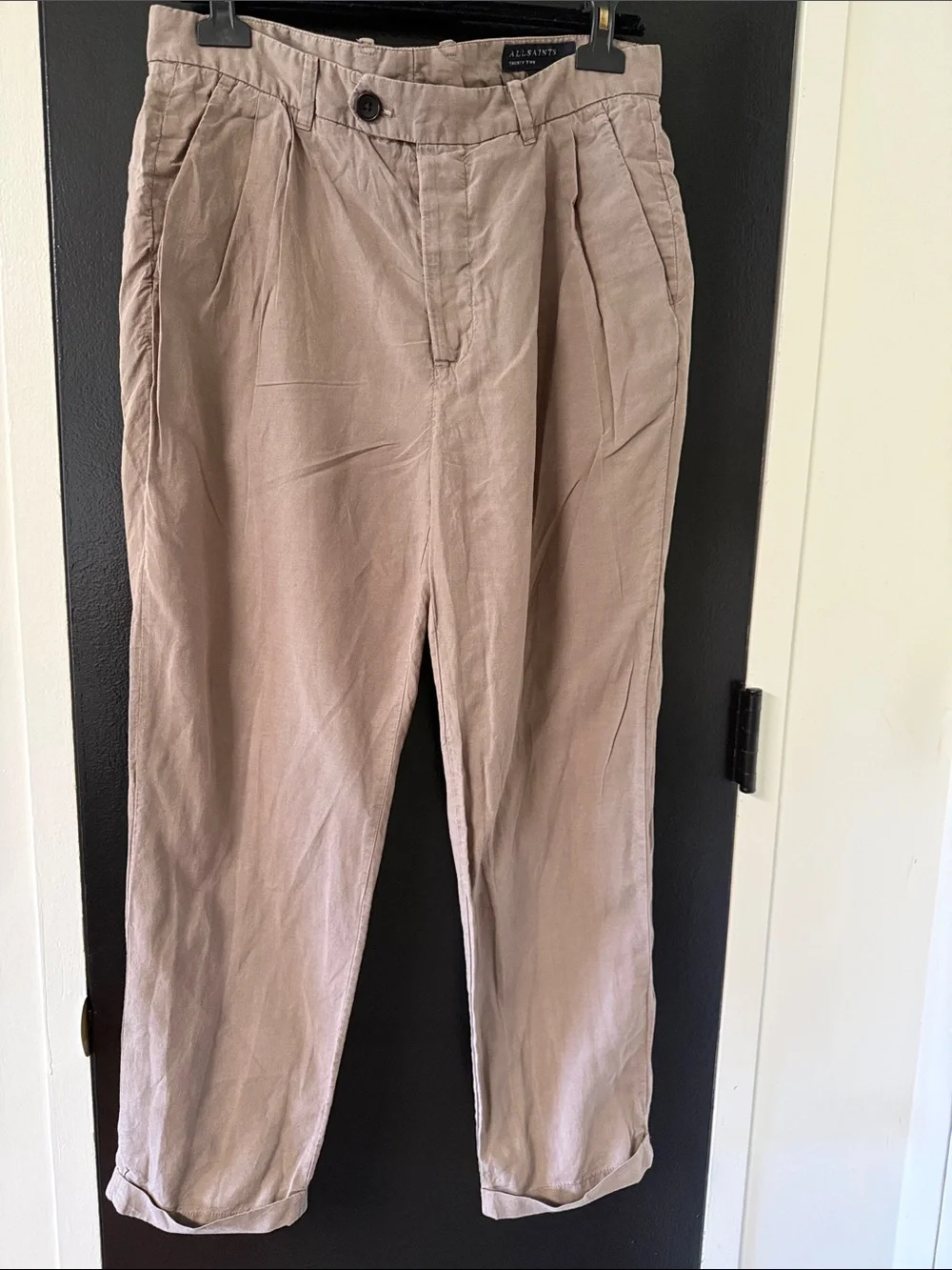 AllSaints trousers with a pleated front and a button closure